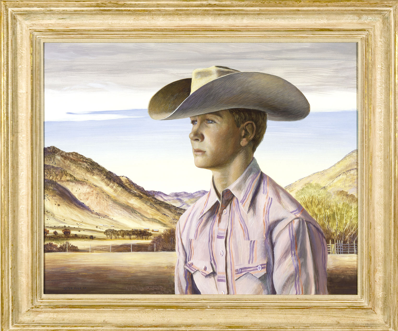 Young man in cowboy hat, purple shirt with orange stripes, mountains in background