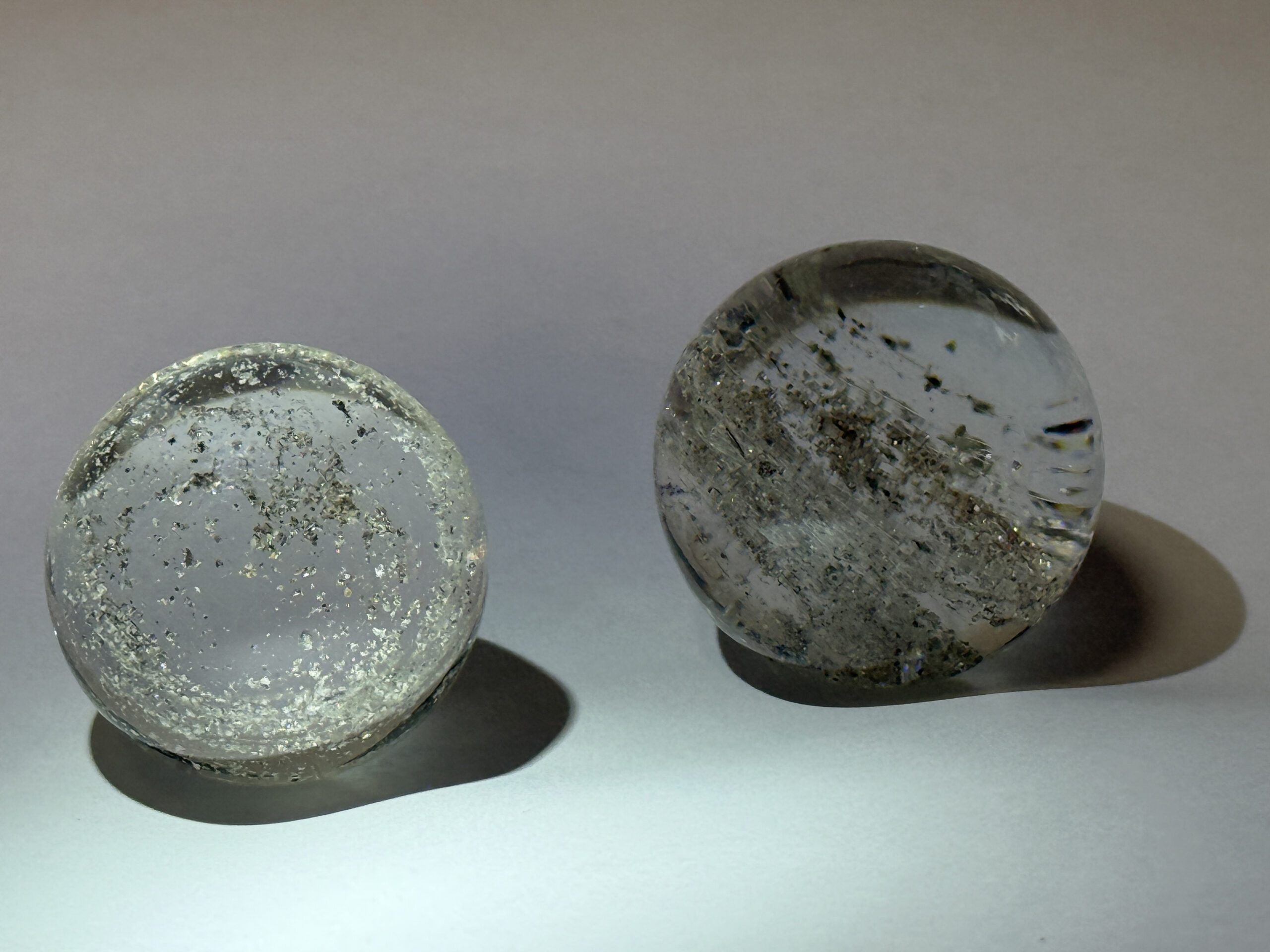 Two glass marbles fill the frame against a white background