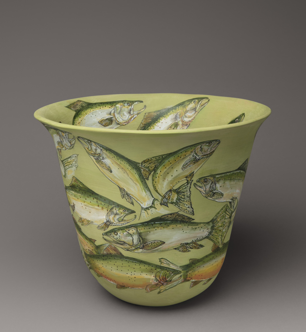A green vase covered in images of fish